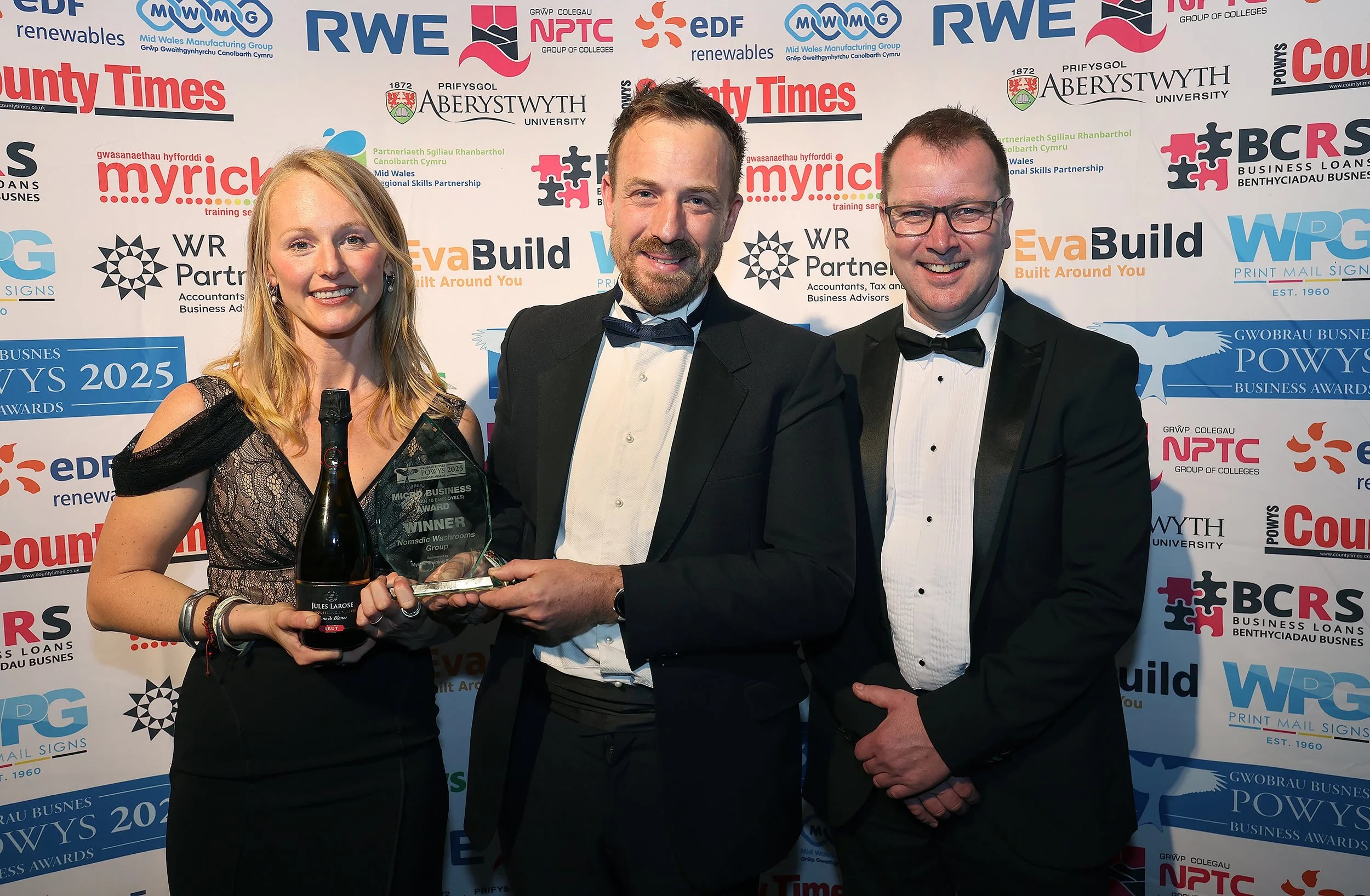 Stuart (centre) and Kate Richards, owners of Nomadic Washrooms Group, receive the Micro Business Award from Nick Jones of Myrick Training Services, sponsor, who encouraged the couple to enter the Powys Business Awards.